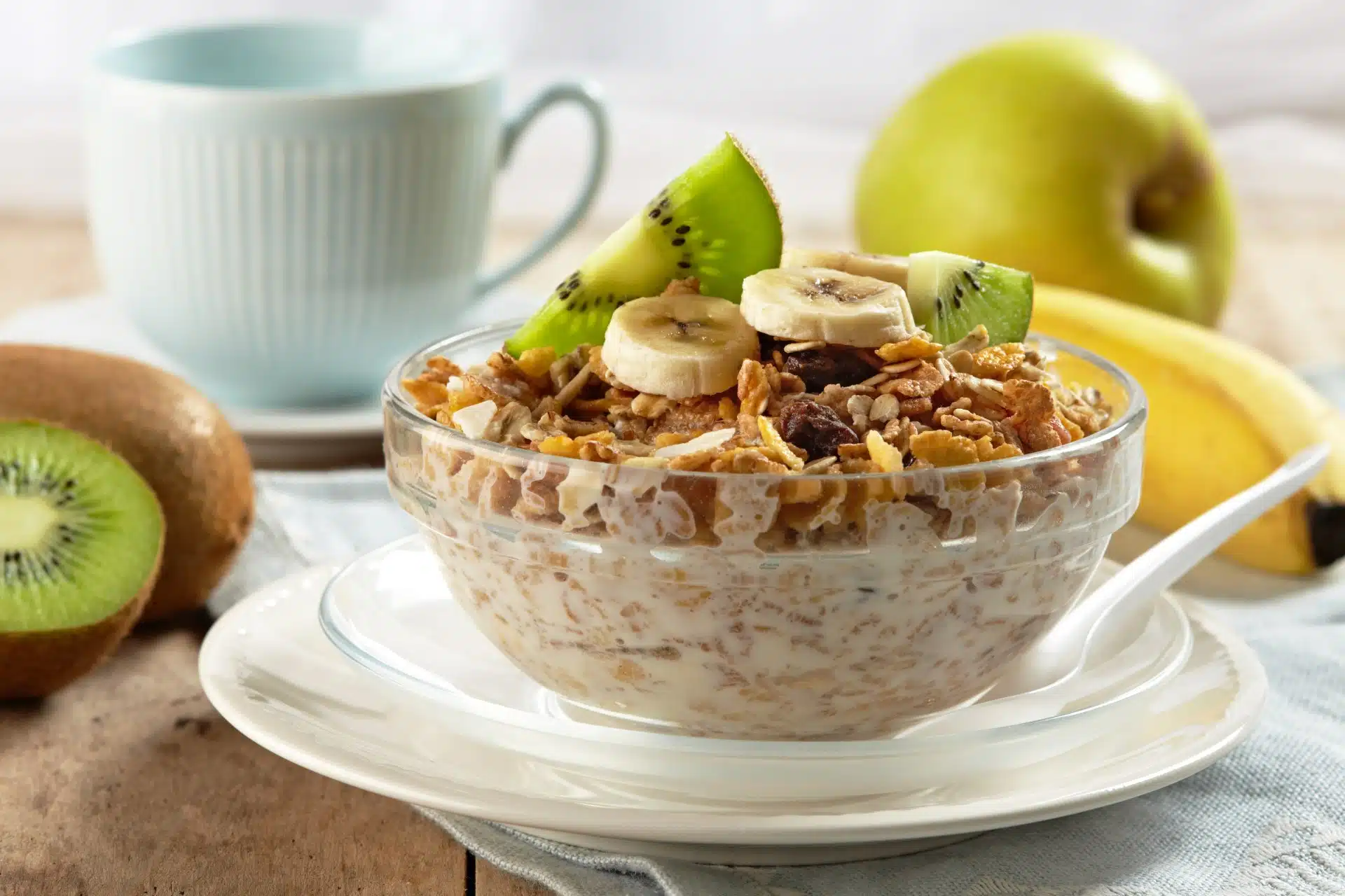 Cereal with fruit in a bowl near a coffee cup and saucer - post foods
