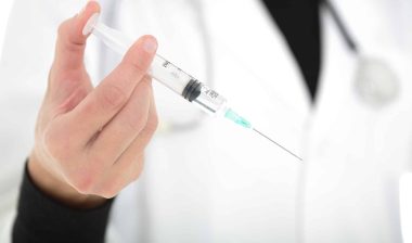 A doctor holding a coronavirus vaccine