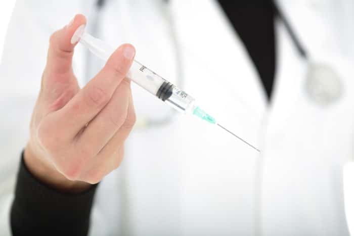 A doctor holding a coronavirus vaccine