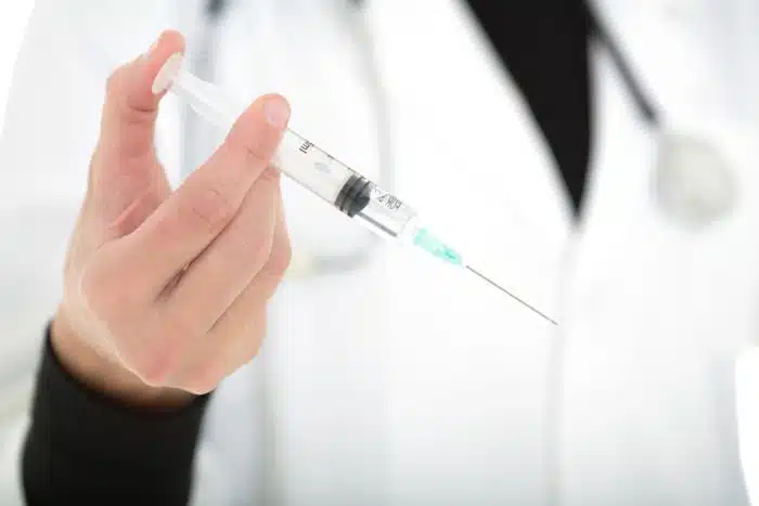 A doctor holding a coronavirus vaccine
