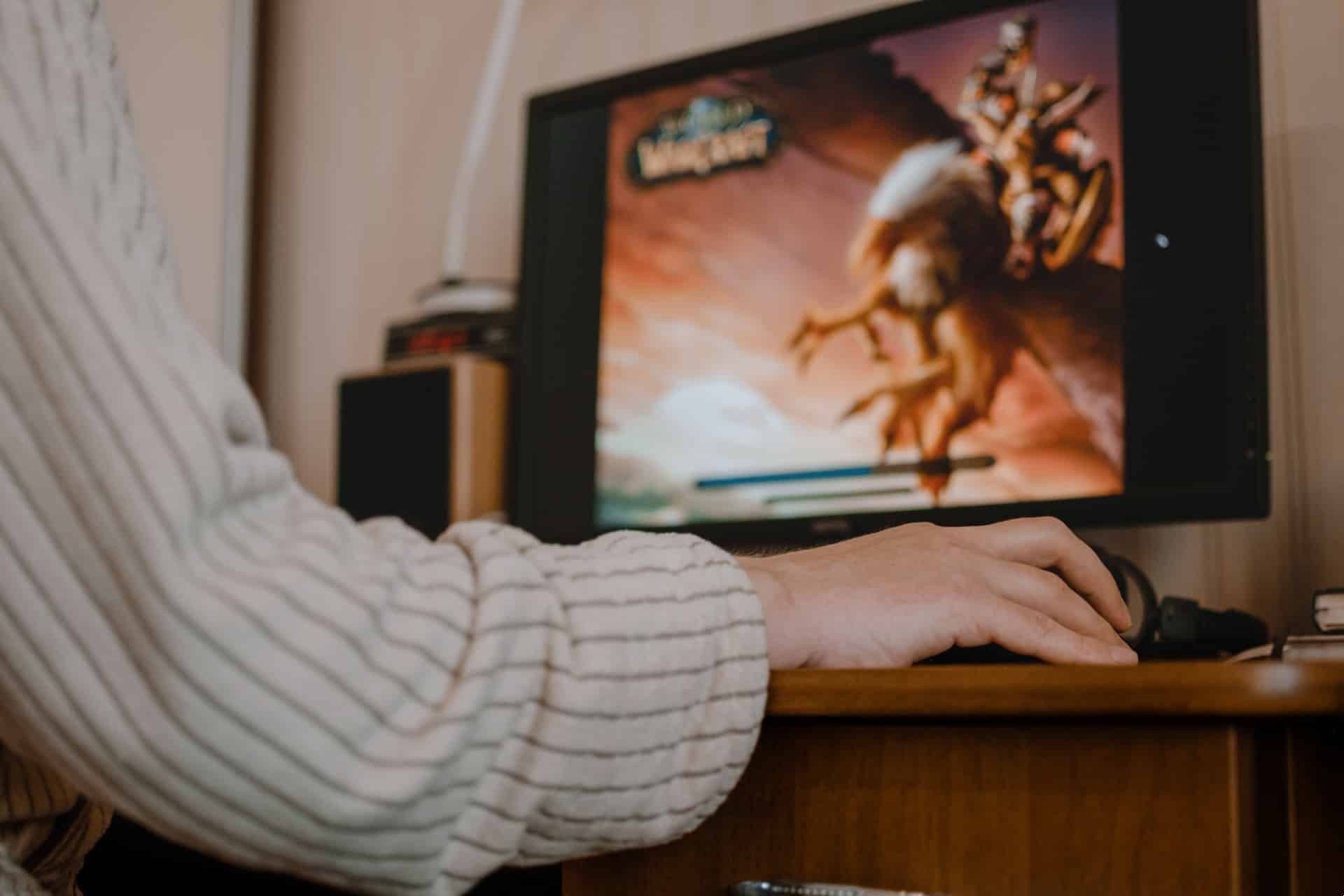 Low shot from behind of a person playing World of Warcraft - World of Warcraft website
