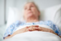elderly sock woman in bed