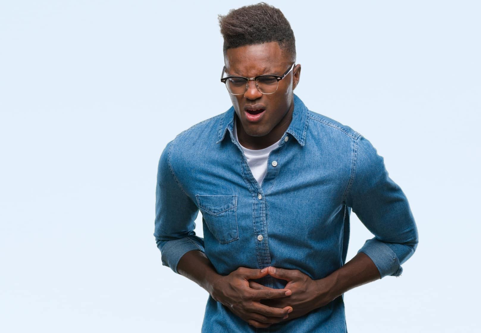 Man holds stomach in pain
