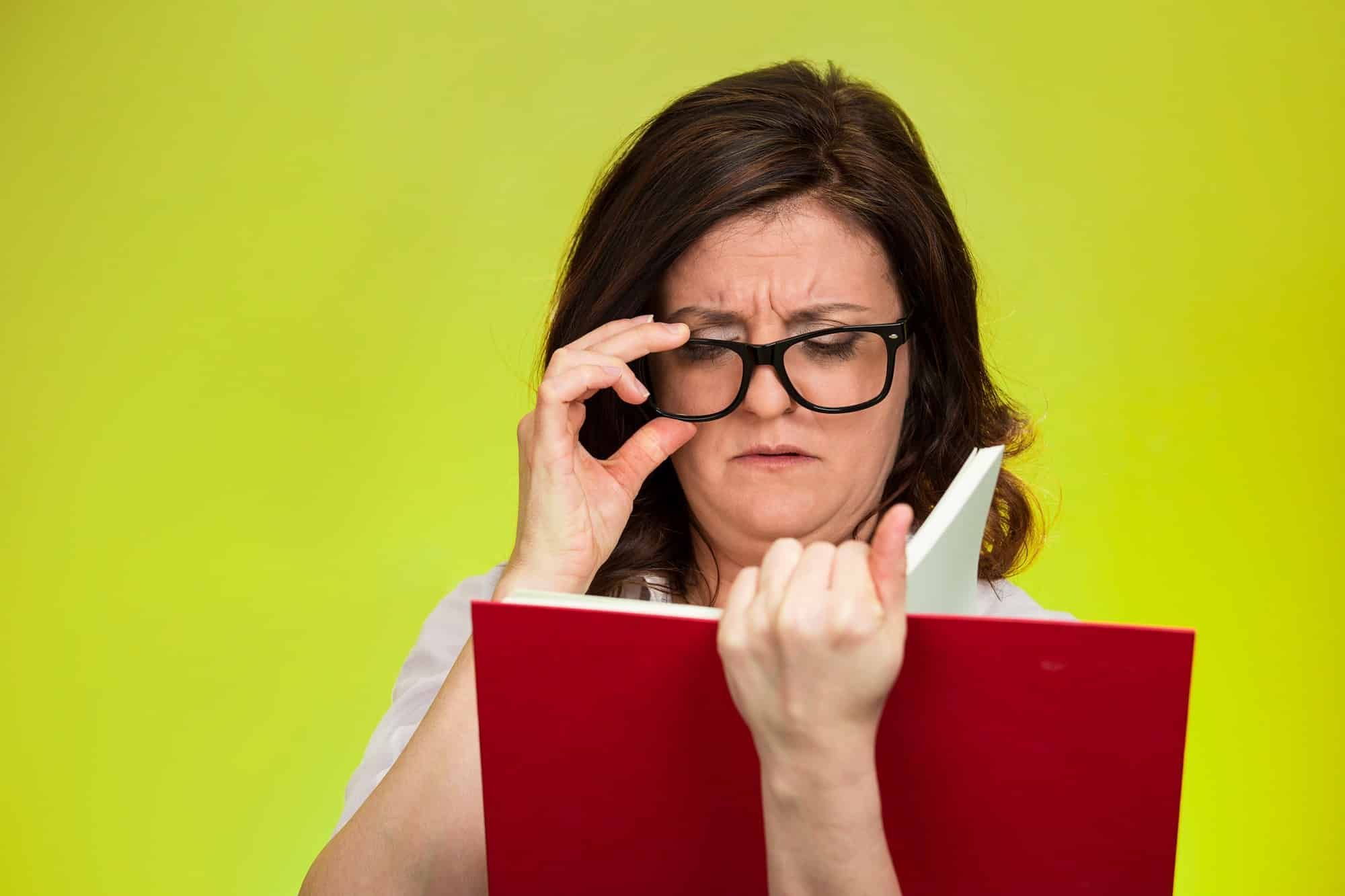 Woman having trouble reading words in book