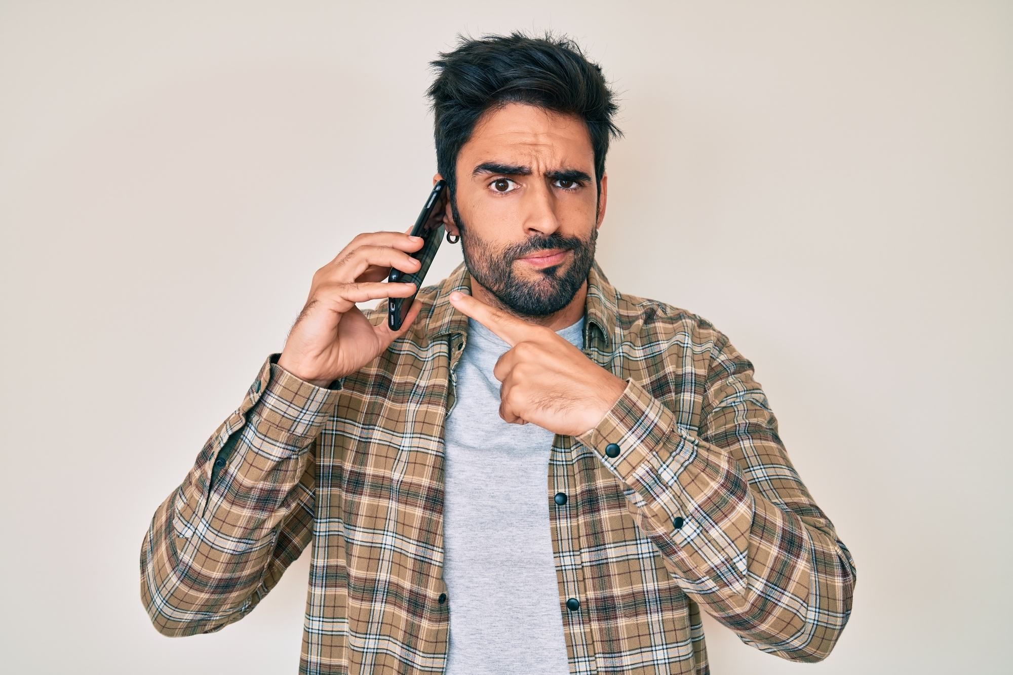 man dealing with annoying spam calls