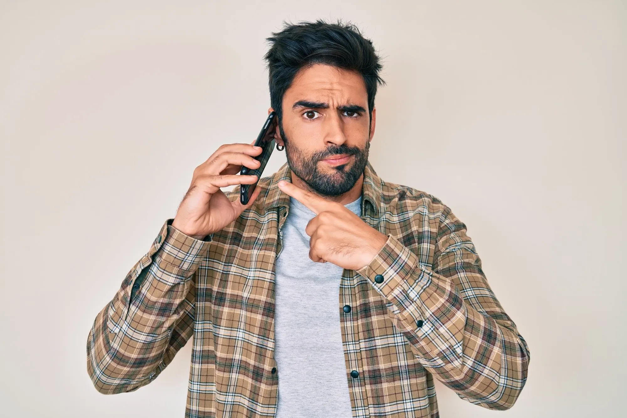 man dealing with annoying spam calls