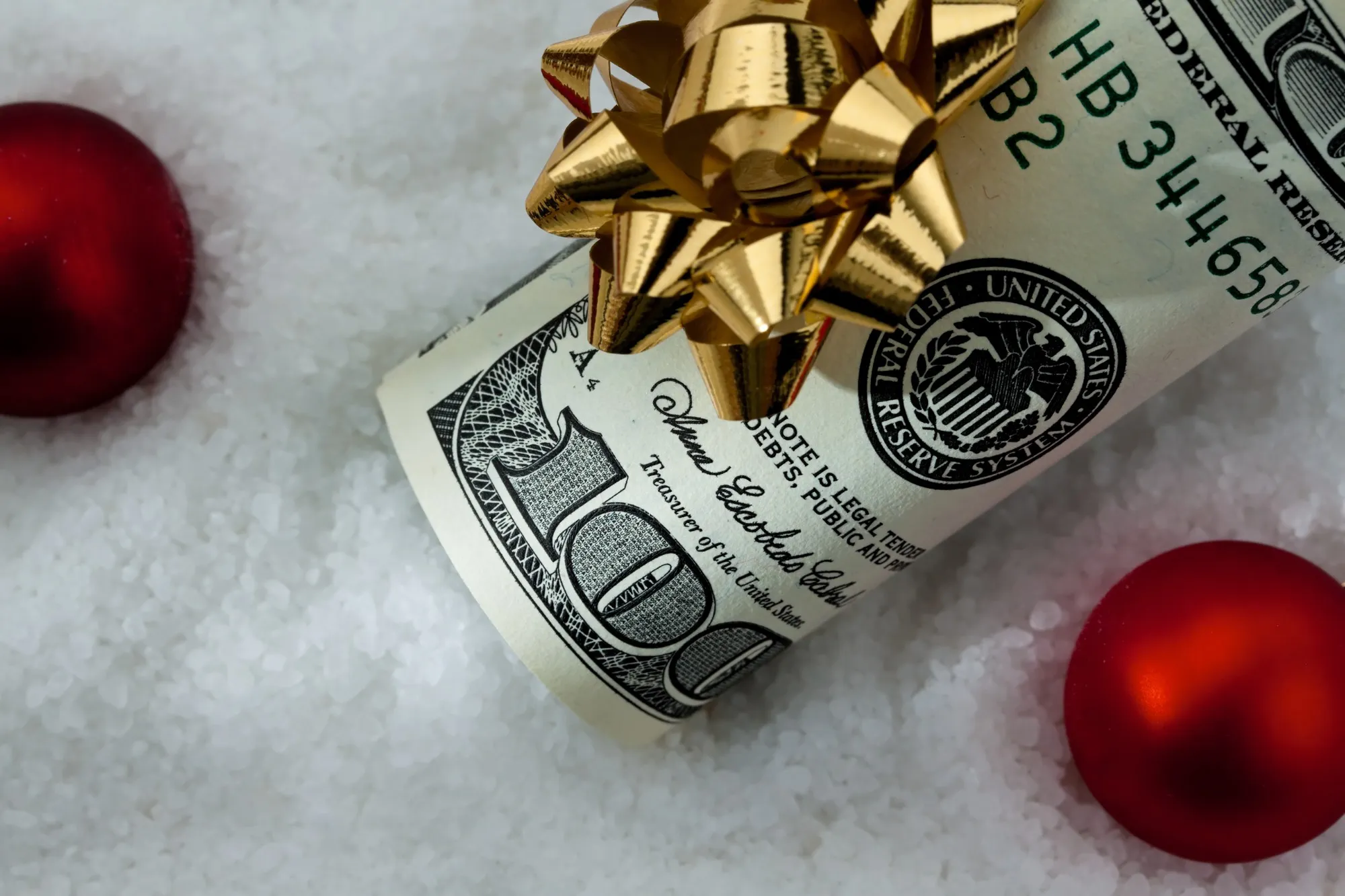 Money wrapped in gold bow