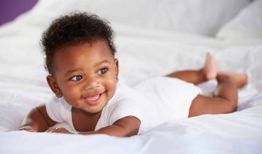 infant on bed after taking Little Remedies pain reliever