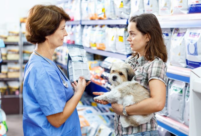 Owner talking with vet over food labeling