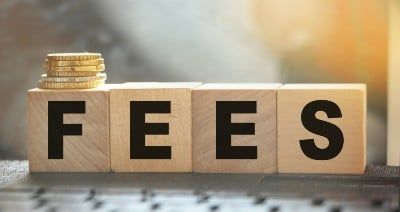 "Fees" spelled out in letter blocks with coins on top of the F - AAA fees