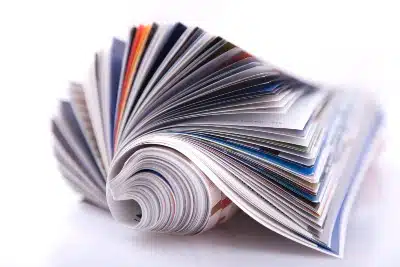 A rolled-up magazine on white background - Autoweek magazine subscription