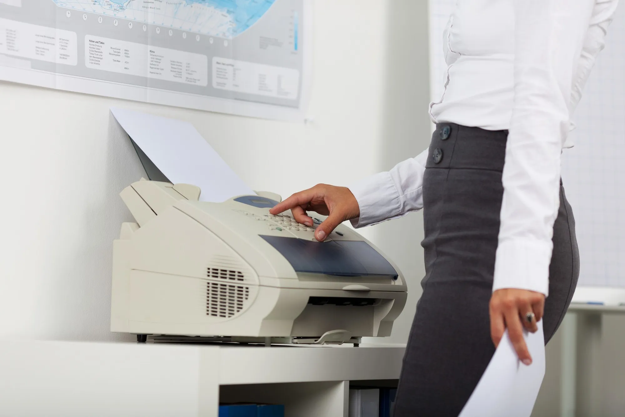Businesswoman at fax machine