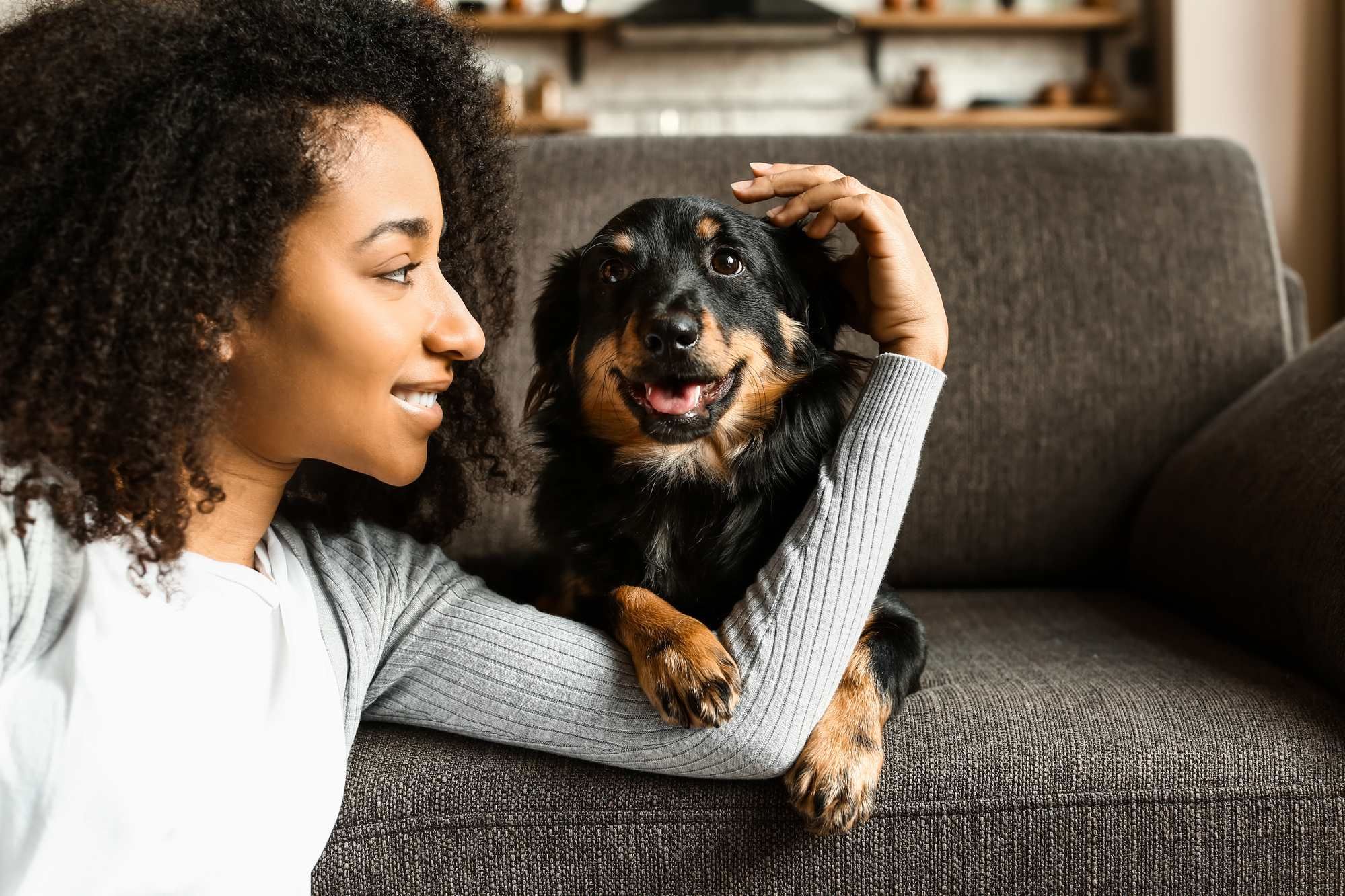 Woman with pup regarding dog food recall deep dive