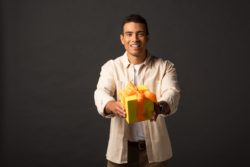 african american male handing over gift