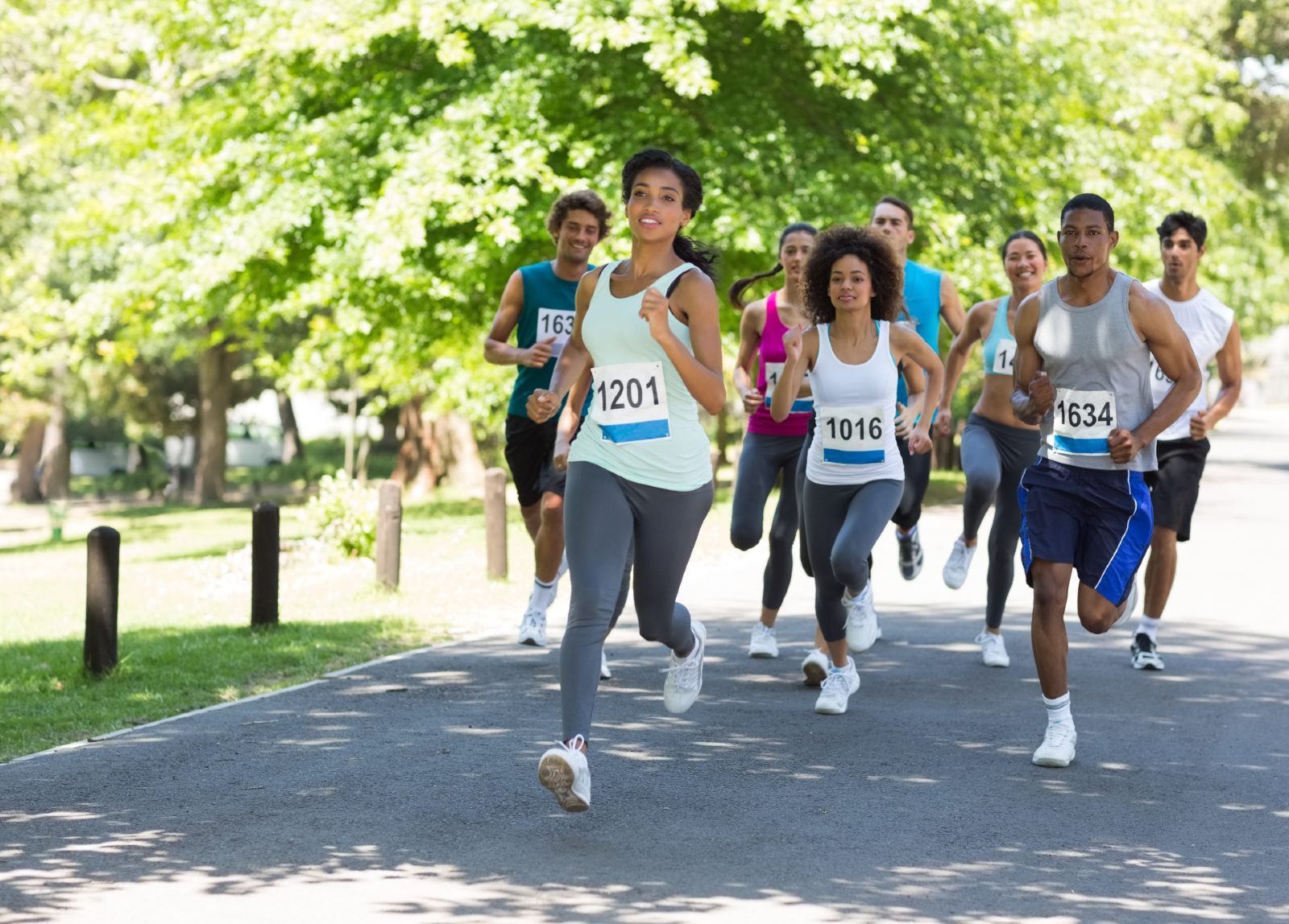Race participants run in a park - Ironman race