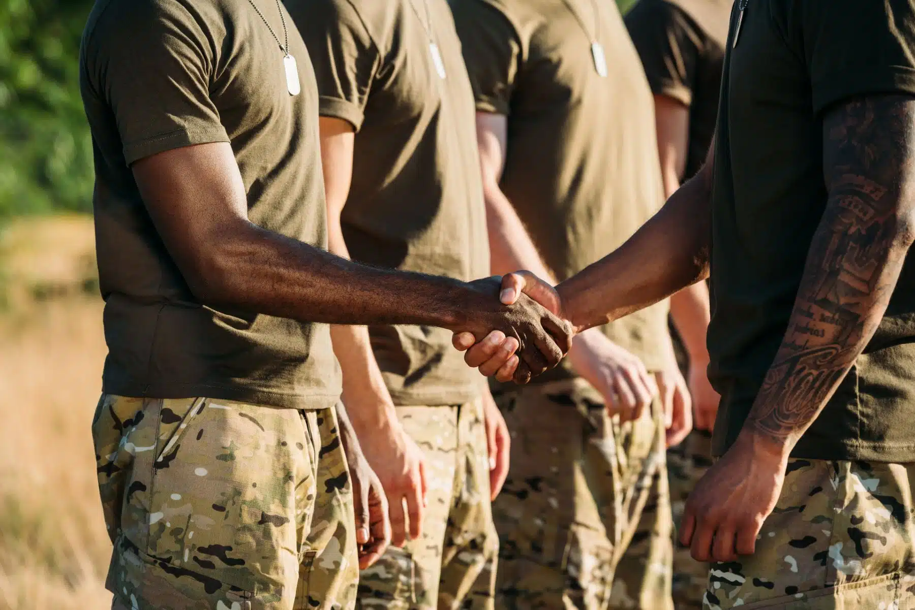 An instructor shakes hands with the first soldier in a line - military leave