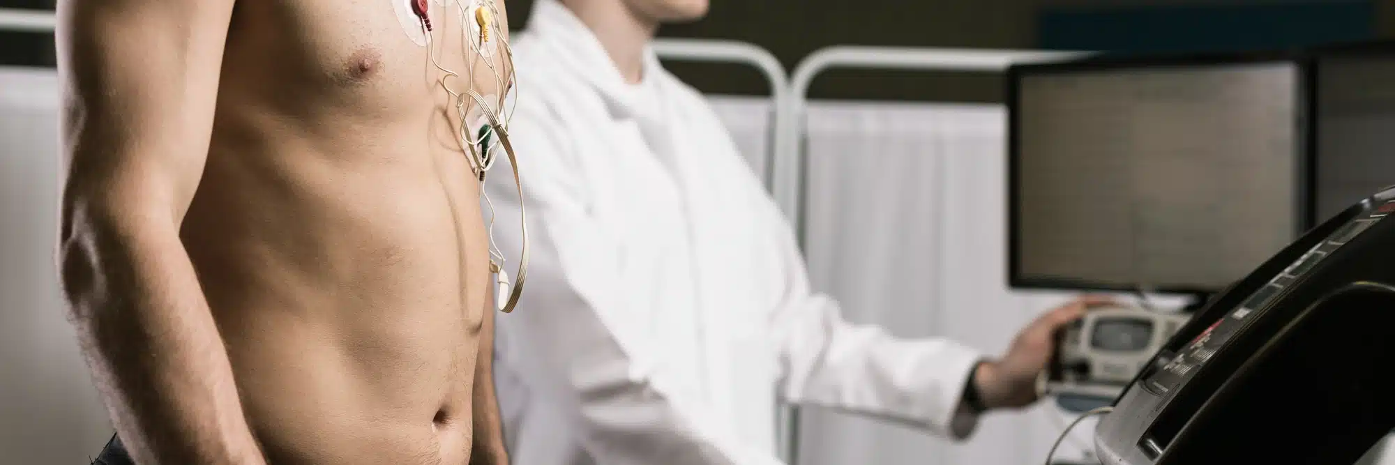 female doctor checking male patient heart rhythm