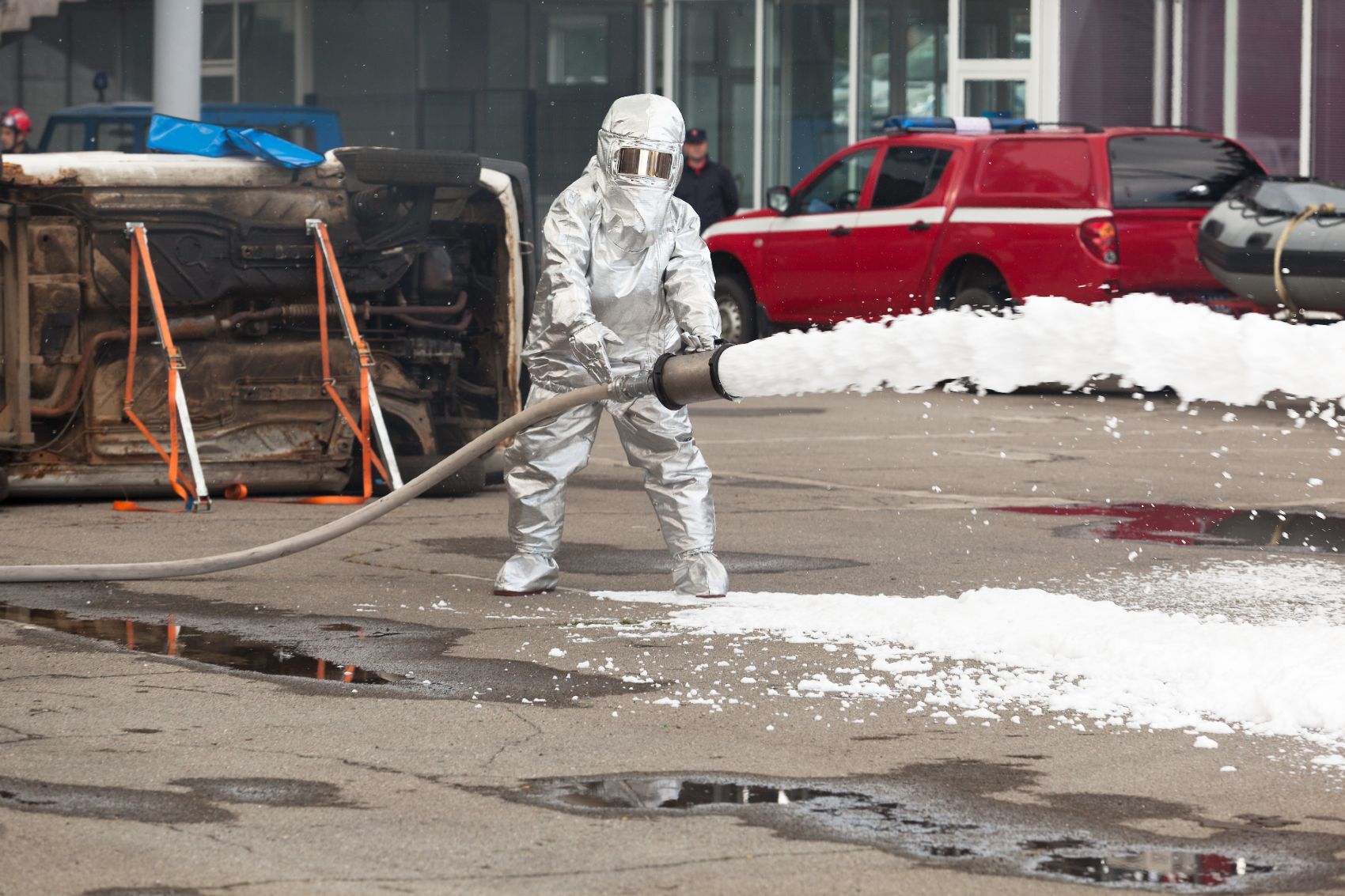 Firefighter uses foam to extinguish a fire - forever chemicals