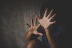 Young girl holds her palms up toward the camera, blocking her face - ymca