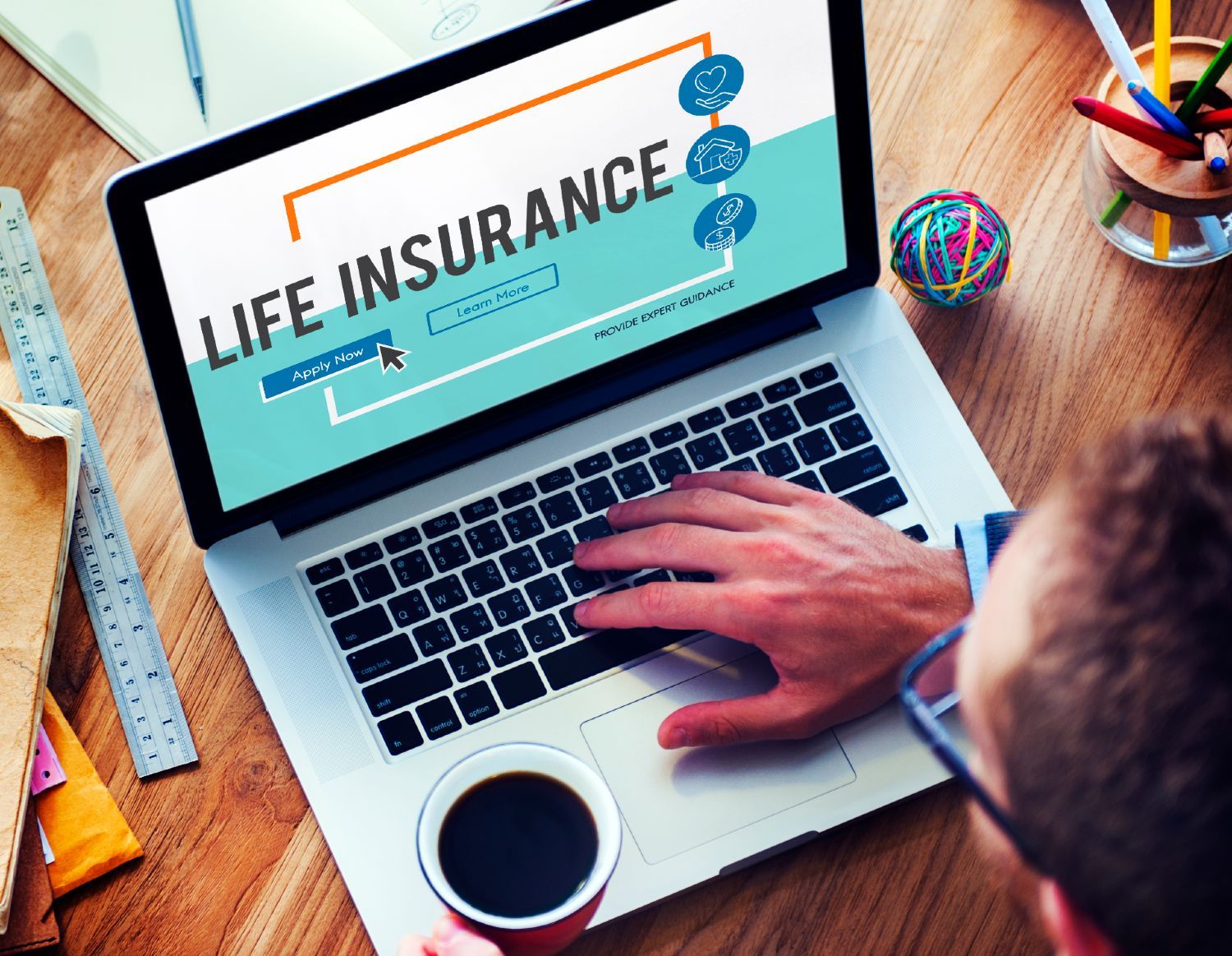 A man looks at life insurance on a laptop - paclife