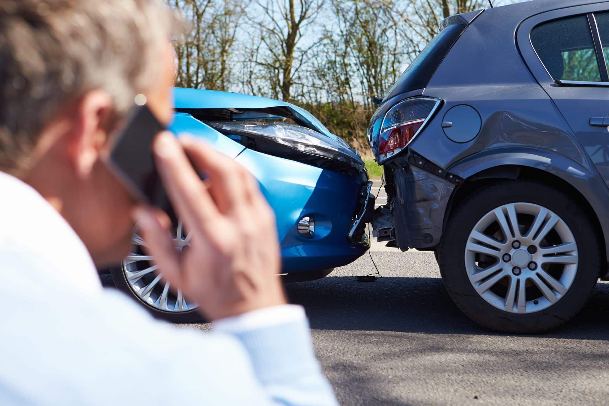man-reporting auto accident to his insurance