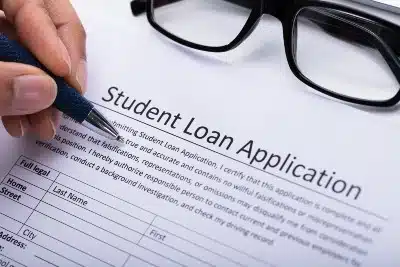 A person fills out a student loan appilcation - pheaa