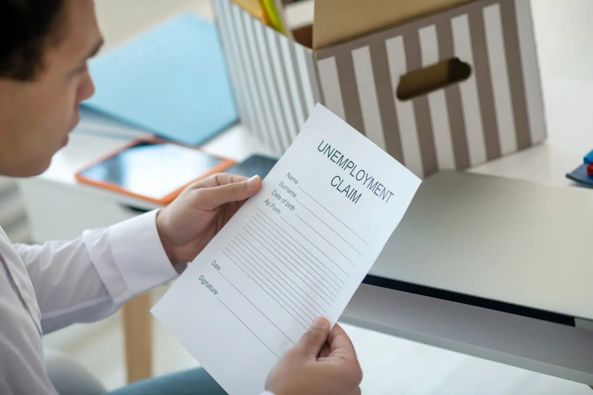 Man holds an unemployment claim form - Oregon unemployment
