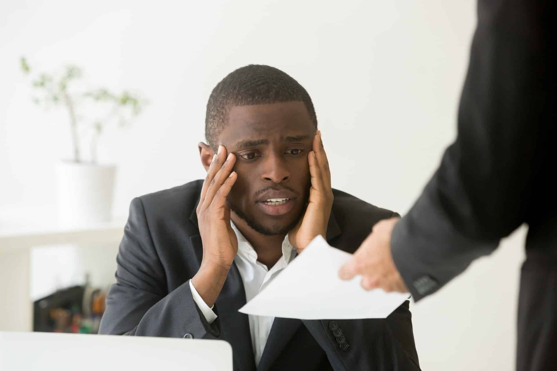 Frustrated Black employee gets a paper from a coworker - Edward Jones