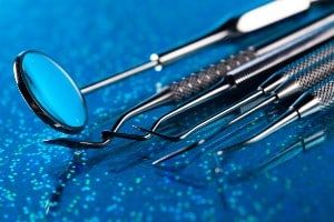 Dental tools on a sparkly blue surface - Nova Southeastern University