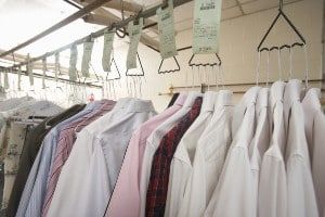 Clothes hang with receipts at a dry cleaner's - wells fargo