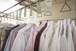 Clothes hang with receipts at a dry cleaner's - wells fargo