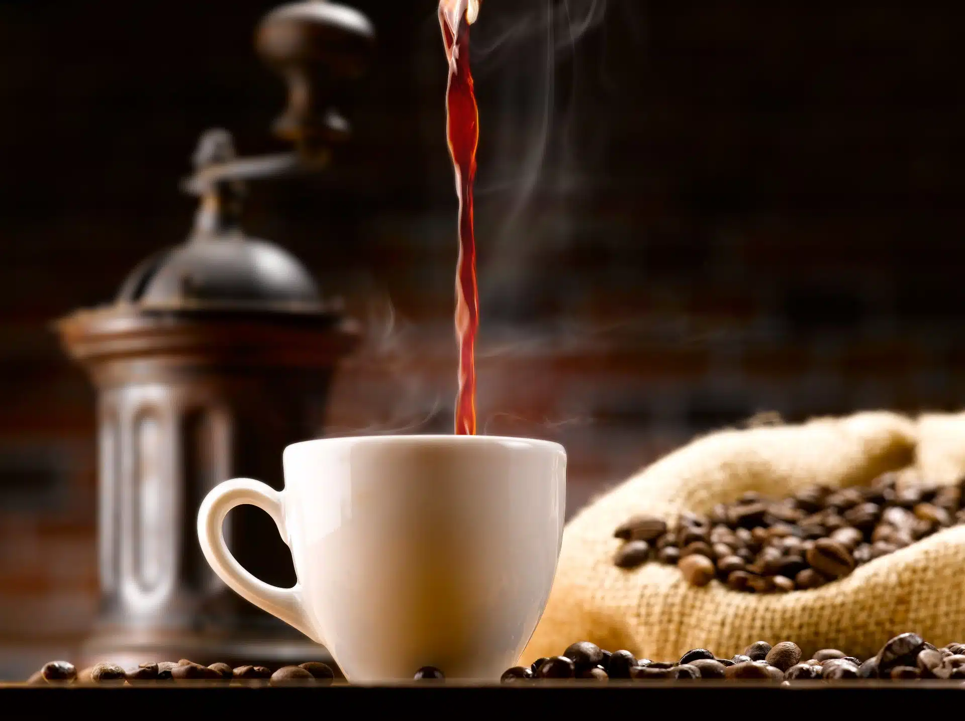 Coffee is poured into a cup surrounded by a grinder and coffee beans - maxwell house settlement