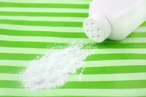 Spilled talcum powder on a striped green surface - baby powder