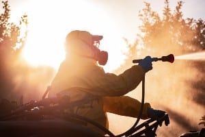 A man in protective gear sprays weed killer - roundup