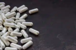 Off-white supplements on a dark grey surface - walmart glucosamine joint supplements - rejuvenation - anti-aging - quantum wellness