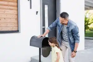 Man and young girl check empty mailbox - settlement payout