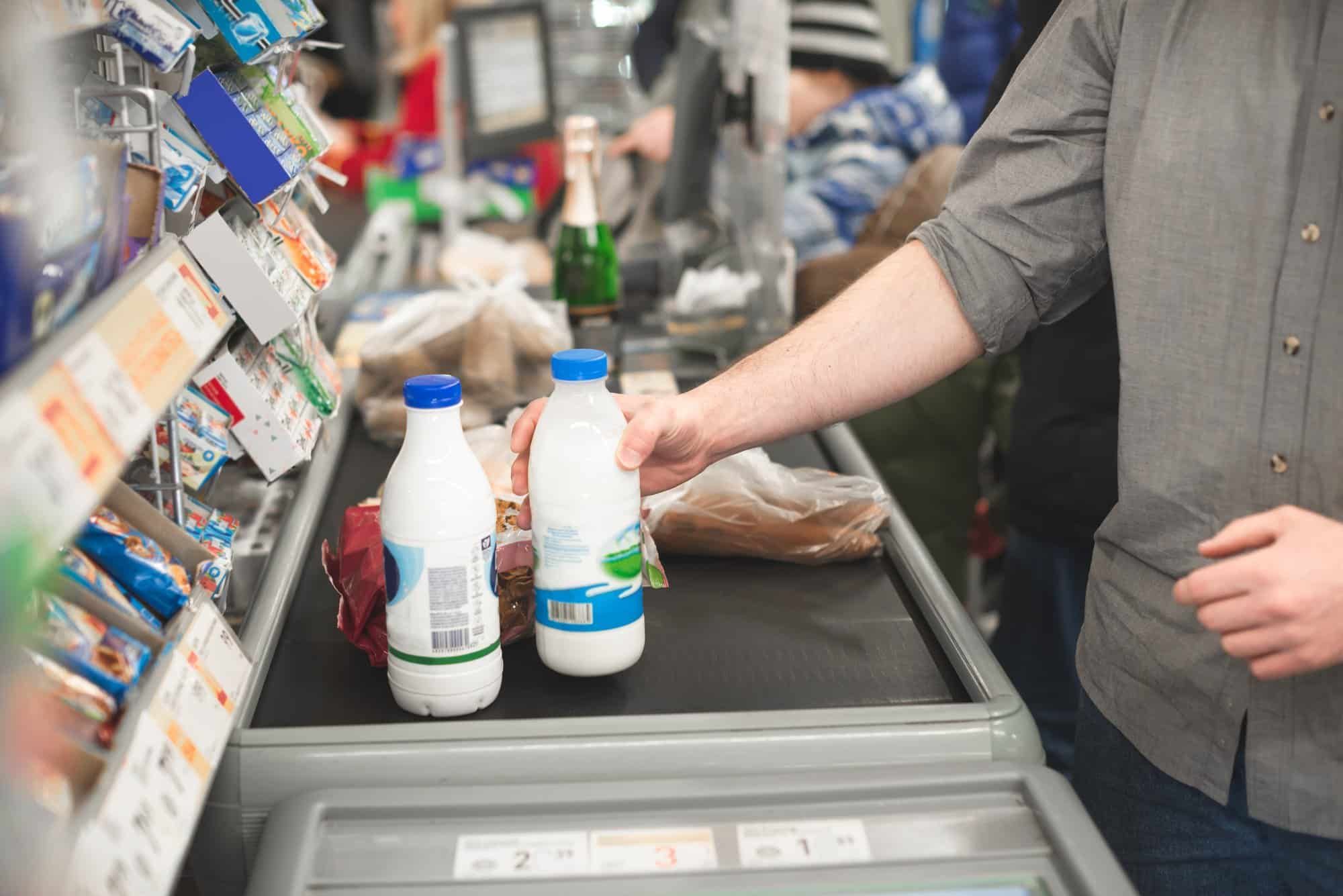 person paying for groceries at cashier