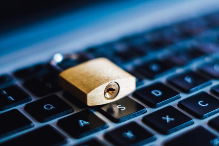 A gold padlock lies on a computer keyboard - navicent health
