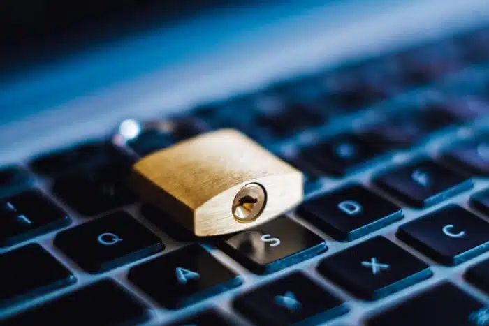 A gold padlock on a computer keyboard - icanvas data breach - icanvas settlement