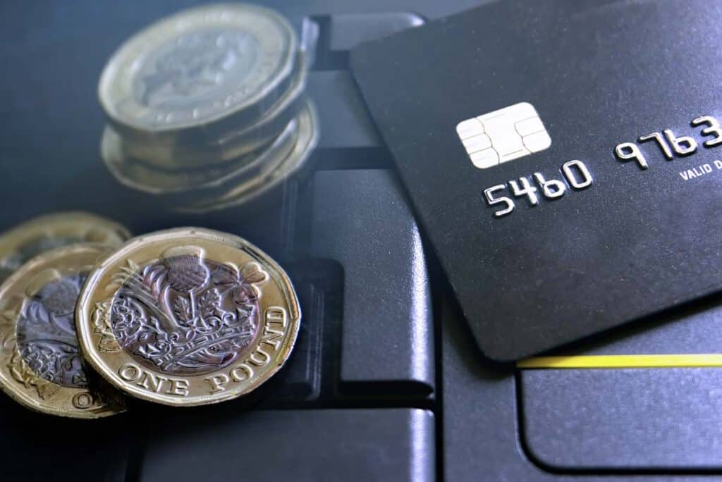 A payment card next to foreign currency, representing the Bank of America forex lawsuit.