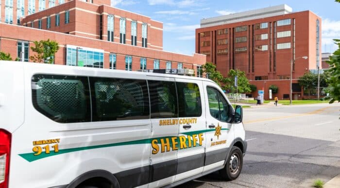 A Shelby County sheriff's van sits near a brick building - shelby county jail - detention settlement - shelby county lawsuit