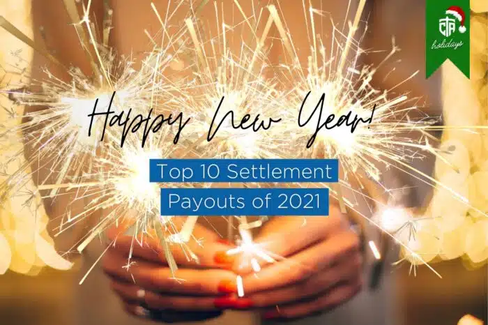 Woman's hands holding sparklers. Text on Image "Happy New Year! Top 10 Settlement Payouts of 2021"