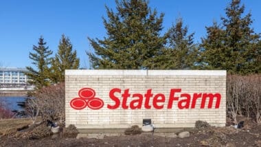 Aurora, Ontario, Canada - April 22, 2018: Sign of State Farm with Aurora Operations Centre in background near Toronto, Canada. State Farm is a large group of insurance and financial services companies; State Farm, class action, insurance