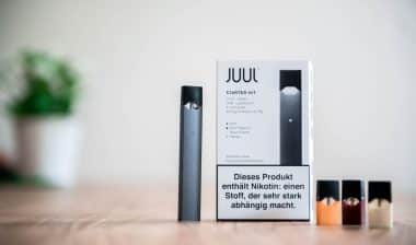 A JUUL Starter Kit on a table. juul, altria, and class action