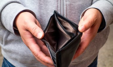 The man has an empty wallet in his hand