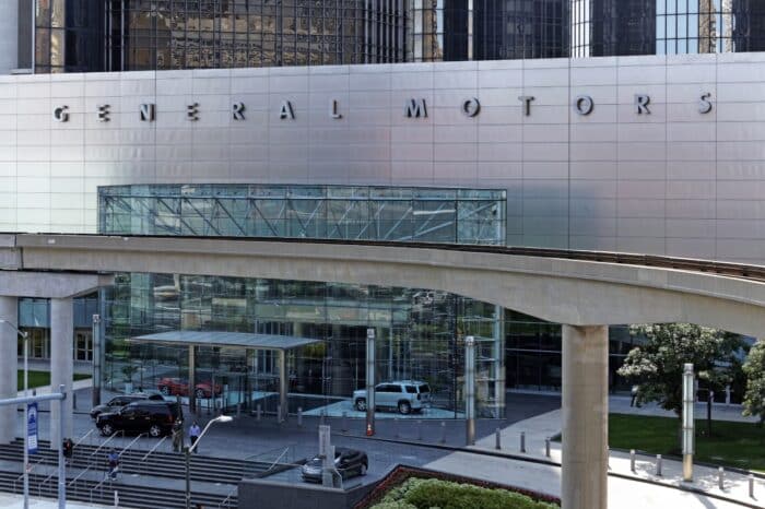 People exit the General Motors World Headquarters building located in Detroit,