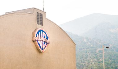 Warner Brothers logo on a building in Burbank. wages, class action