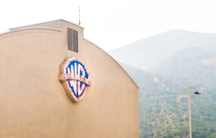 Warner Brothers logo on a building in Burbank.  wages, class action