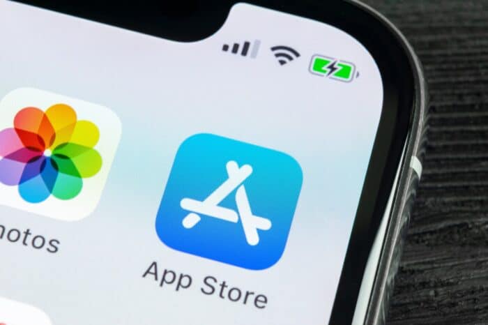 Apple store application icon on Apple iPhone X smartphone screen close-up.  - apple class action settlement - app developers