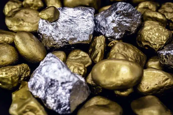 Gold and silver nuggets on black background. Precious stones